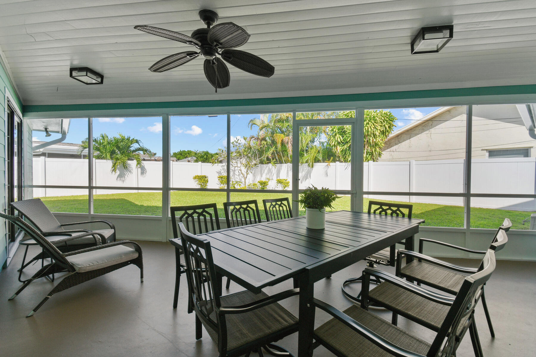 4153 Wingo Street Jupiter, FL 33469 - Photo 32 of 39 a view of a patio with a table chairs and a backyard