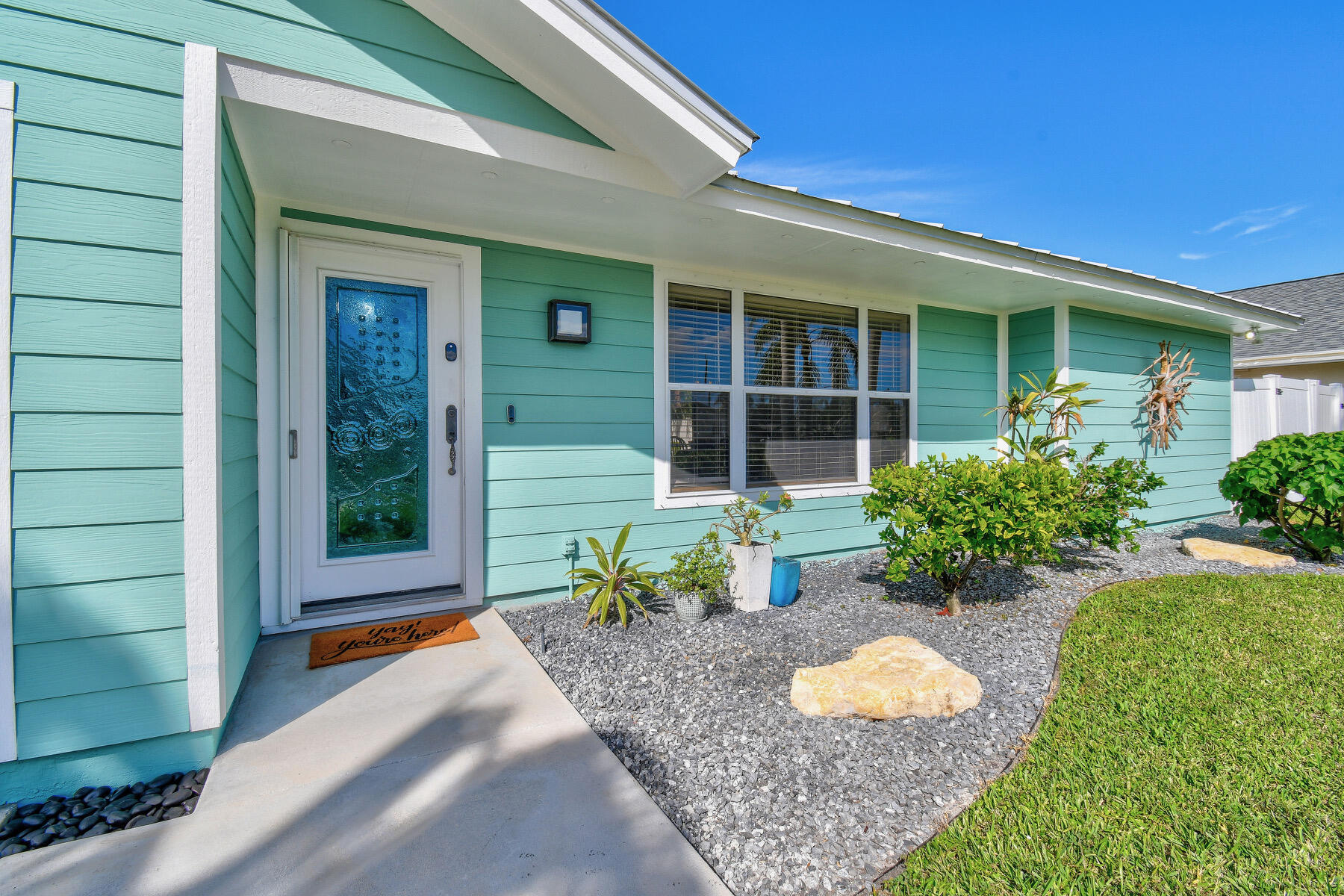 4153 Wingo Street Jupiter, FL 33469 - Photo 4 of 39 a front view of a house with a yard