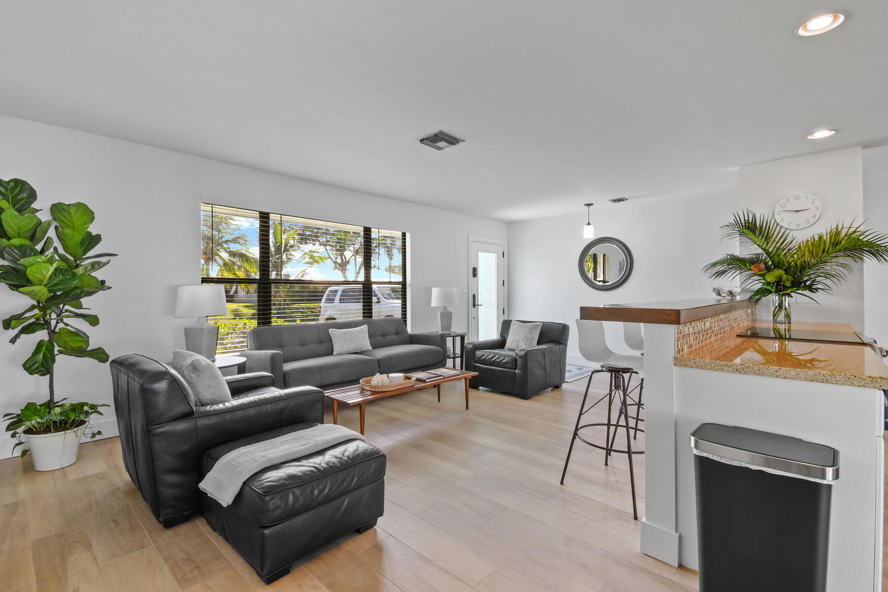 4153 Wingo Street Jupiter, FL 33469 - Photo 8 of 39 a living room with furniture potted plant and a window