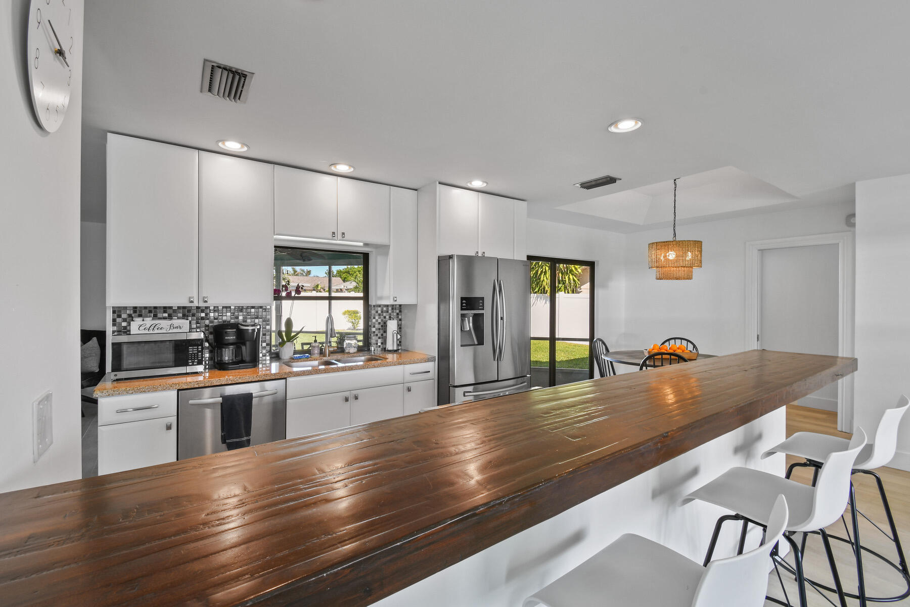 4153 Wingo Street Jupiter, FL 33469 - Photo 9 of 39 a kitchen with stainless steel appliances granite countertop a sink and cabinets