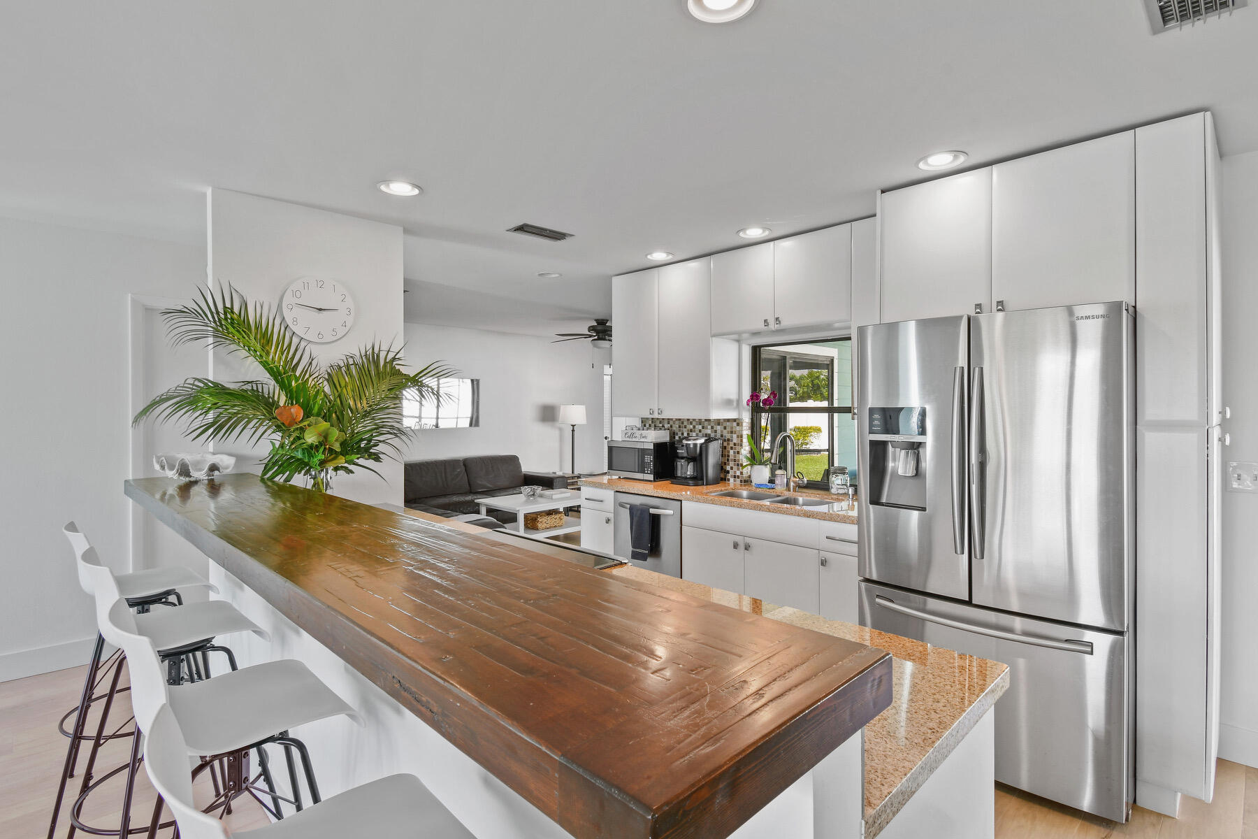 4153 Wingo Street Jupiter, FL 33469 - Photo 10 of 39 a kitchen with kitchen island a counter appliances and cabinets