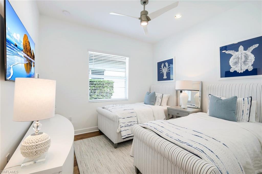 11322 Jacaranda Drive Naples, FL 34120 - Photo 14 of 42 a bedroom with two beds and a window