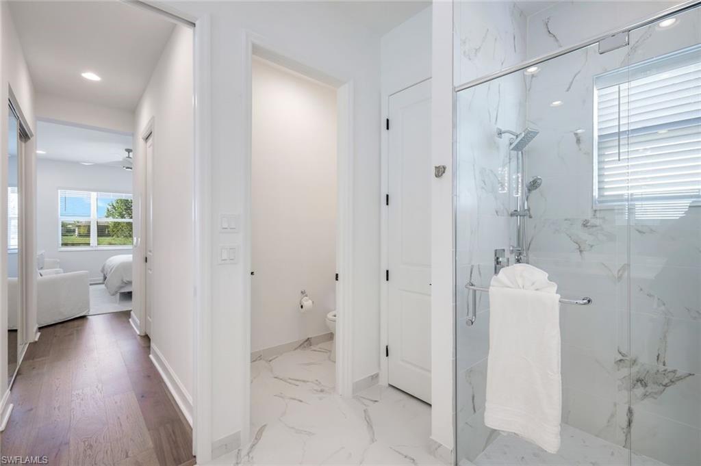 11322 Jacaranda Drive Naples, FL 34120 - Photo 15 of 42 a bathroom with a sink and shower