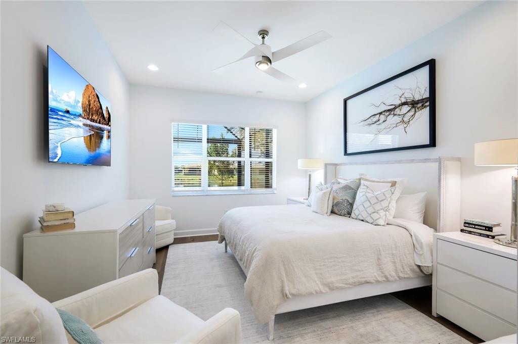 11322 Jacaranda Drive Naples, FL 34120 - Photo 16 of 42 a bedroom with a bed and a painting on the wall