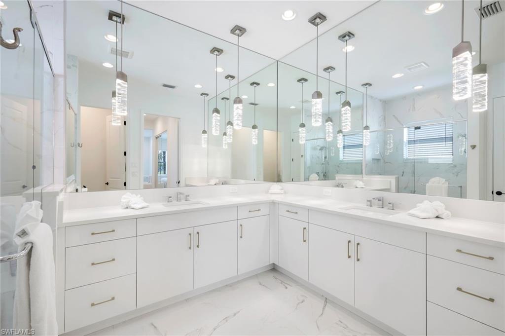 11322 Jacaranda Drive Naples, FL 34120 - Photo 19 of 42 a bathroom with a granite countertop sink mirror and double