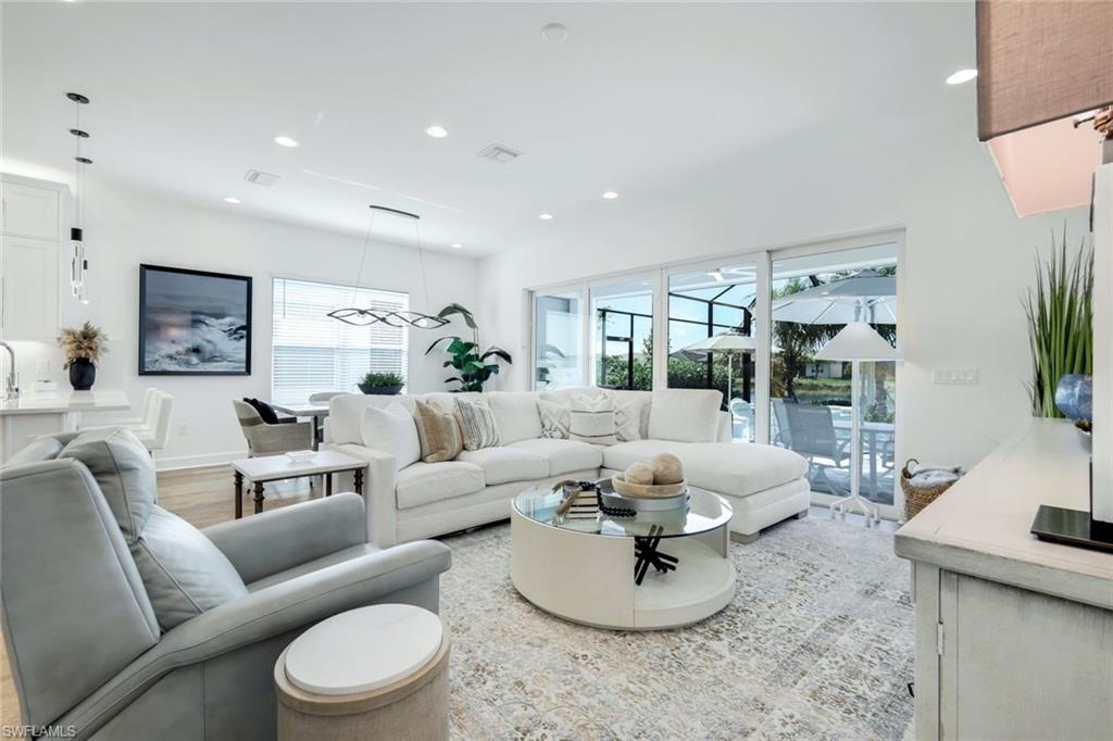 11322 Jacaranda Drive Naples, FL 34120 - Photo 21 of 42 a living room with furniture and a large window