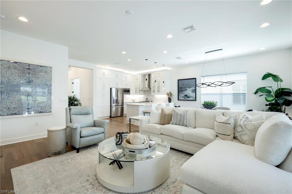 11322 Jacaranda Drive Naples, FL 34120 - Photo 29 of 42 a living room with furniture and a large window