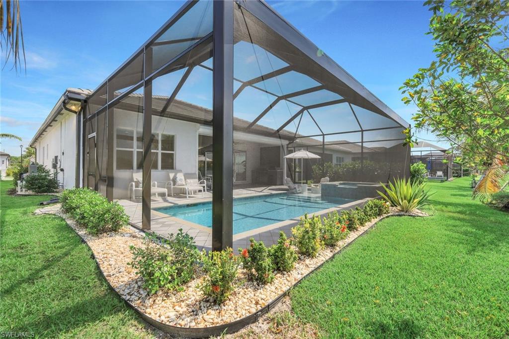 11322 Jacaranda Drive Naples, FL 34120 - Photo 37 of 42 a view of a backyard with porch
