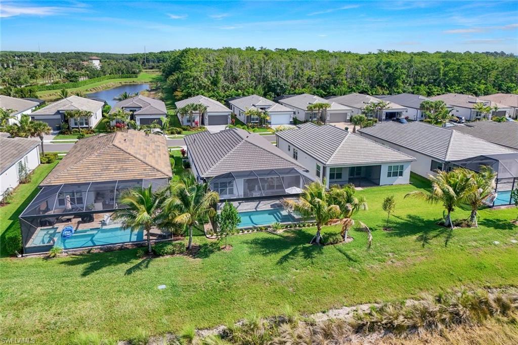 11322 Jacaranda Drive Naples, FL 34120 - Photo 39 of 42 a view of a house with a garden