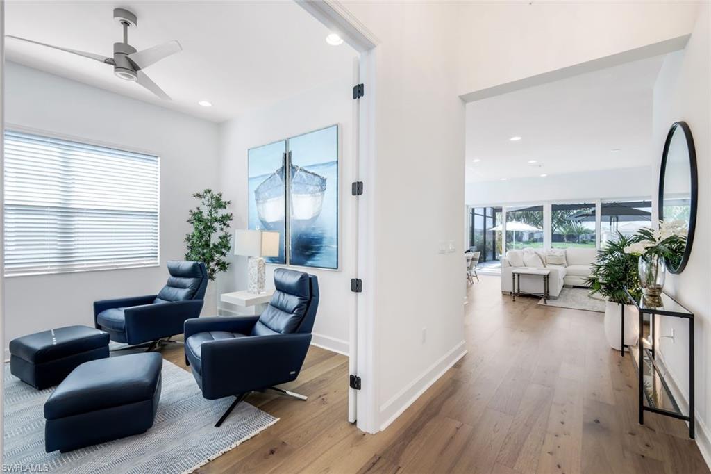 11322 Jacaranda Drive Naples, FL 34120 - Photo 8 of 42 a living room with furniture and a large window