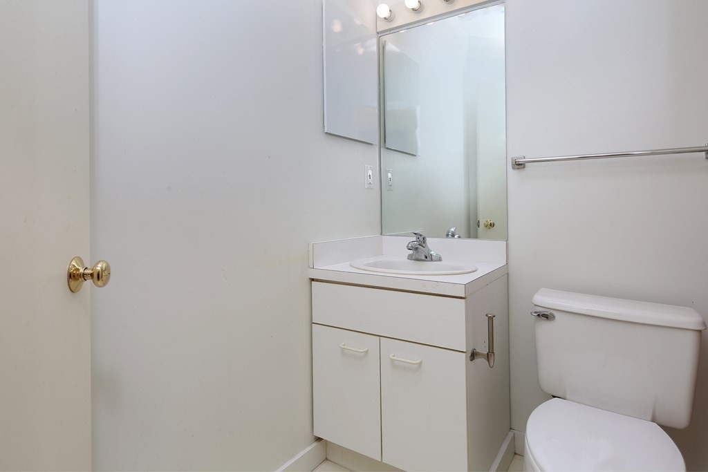 30 Monument Square, Unit 404 Boston, MA 02129 - Photo 11 of 14 a bathroom with a toilet sink and mirror