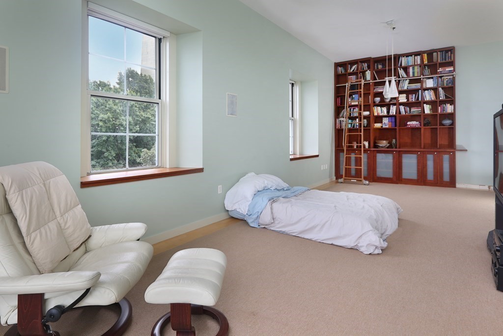 30 Monument Square, Unit 404 Boston, MA 02129 - Photo 3 of 14 a bedroom with a bed and a large window