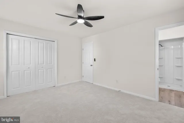 a bedroom with a bed a flat screen tv and a couch