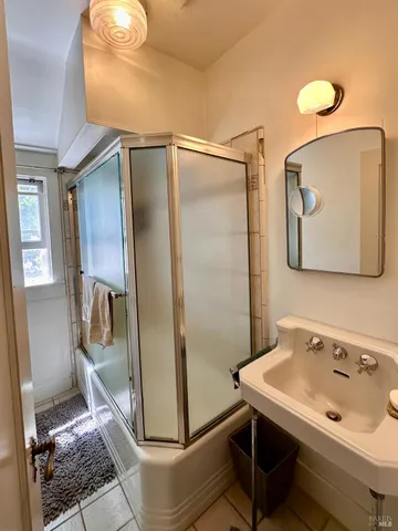 a bathroom with a sink mirror and toilet