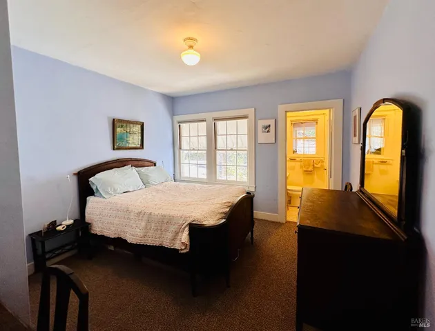 a spacious bedroom with a bed and a window