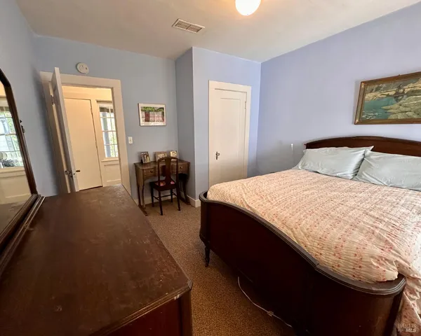 a bedroom with a bed and window