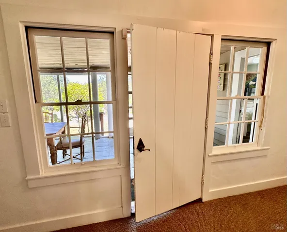 an entryway with wooden floor and door