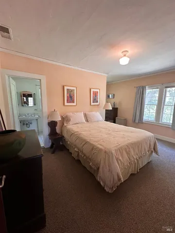 a spacious bedroom with a bed and window