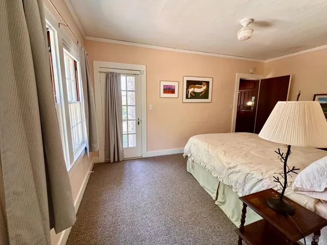 a bedroom with a bed and a lamp