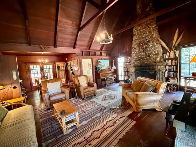 a living room with furniture a fireplace and city view