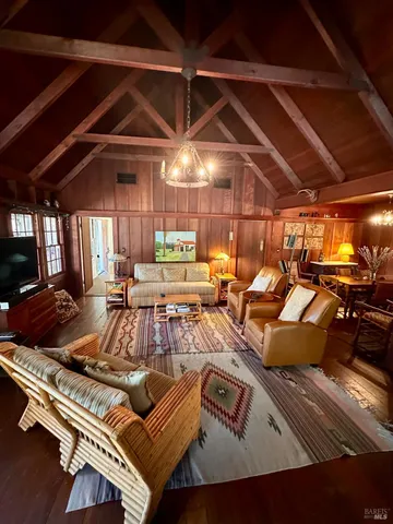 a view of a patio with couches table and chairs and a barbeque