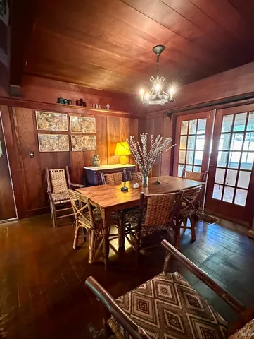 a dining room with furniture and a large window