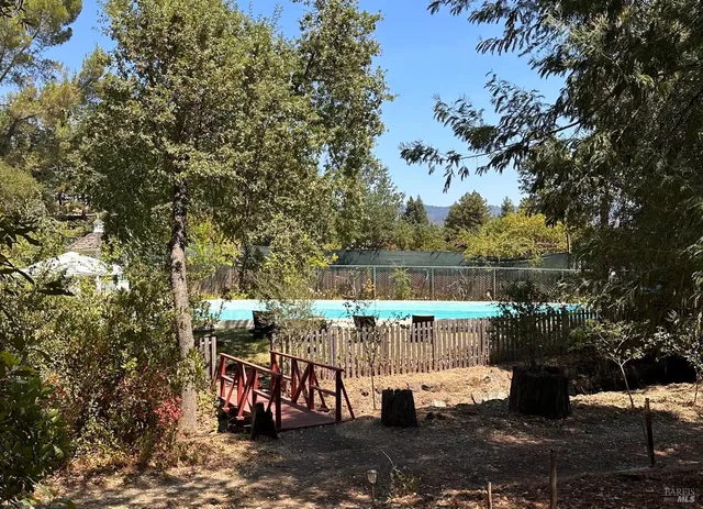 a view of a balcony with wooden chairs