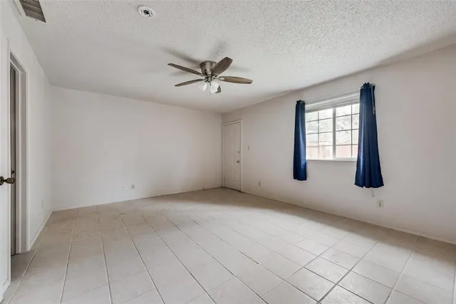 a view of a livingroom with a ceiling fan and window