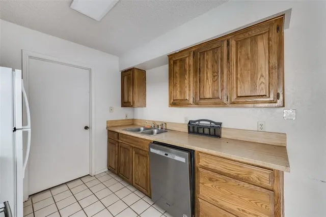 a kitchen with stainless steel appliances granite countertop a stove a refrigerator and a cabinets