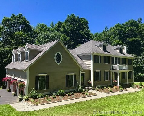 a aerial view of a house with yard porch and furniture