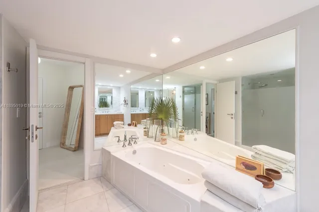 a bathroom with a double vanity sink mirror and shower