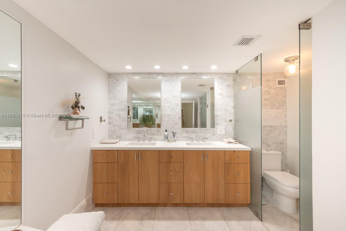 1121 Crandon Boulevard, Unit D402 Key Biscayne, FL 33149 - Photo 12 of 26 a bathroom with a sink a toilet and shower