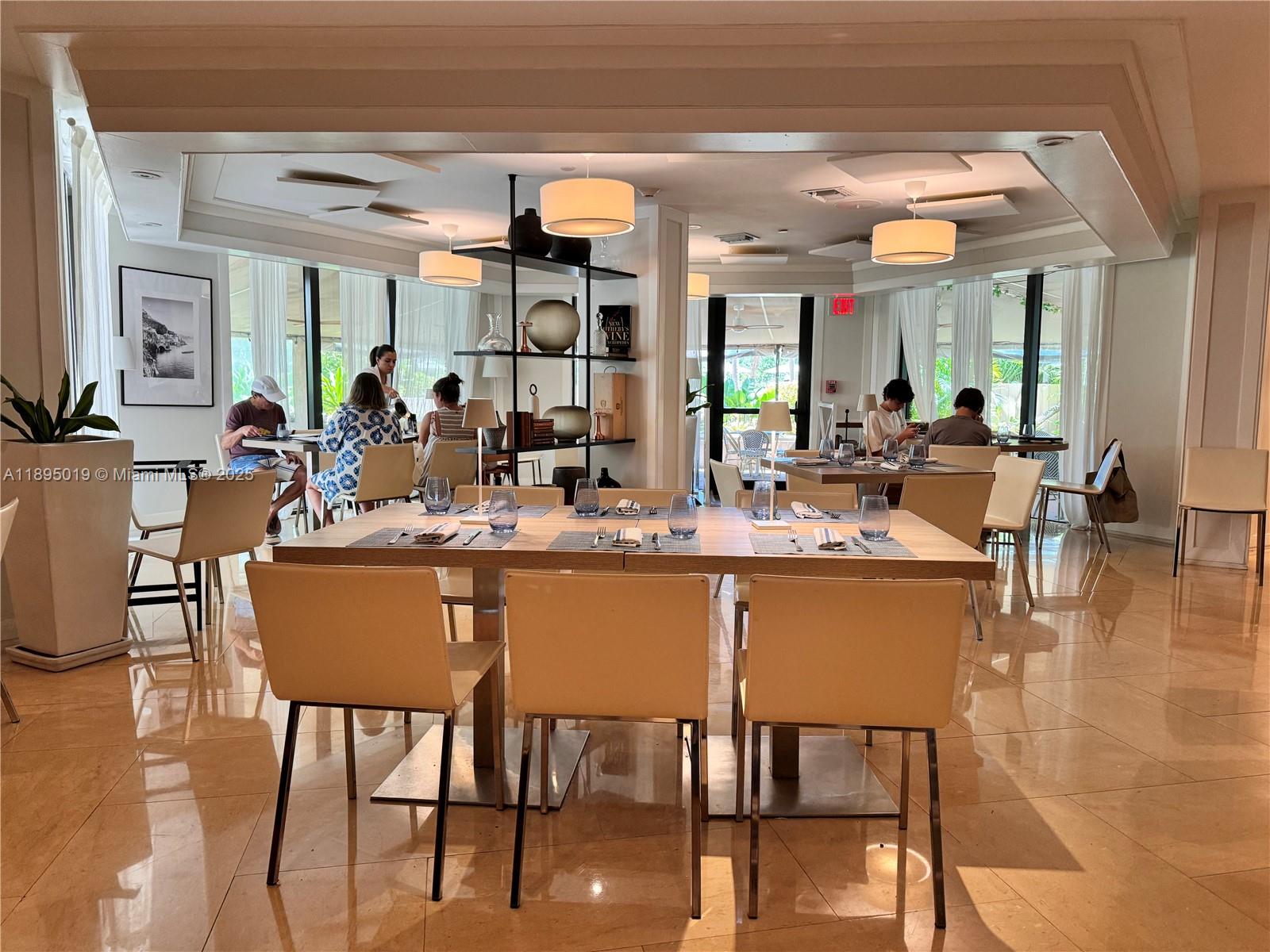 1121 Crandon Boulevard, Unit D402 Key Biscayne, FL 33149 - Photo 23 of 26 a dining hall with stainless steel appliances granite countertop a table and chairs