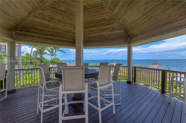 a view of a patio with a table chairs and wooden floor