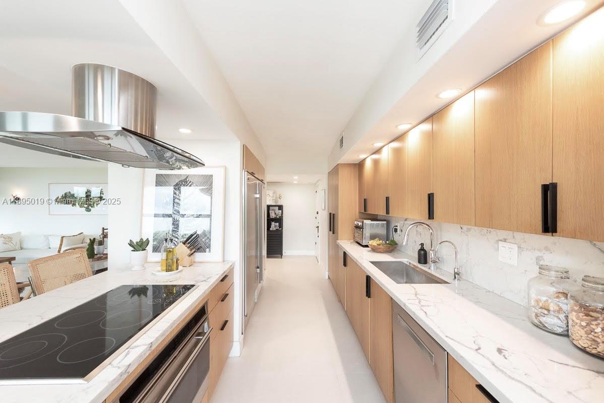 1121 Crandon Boulevard, Unit D402 Key Biscayne, FL 33149 - Photo 8 of 26 a large white kitchen with a large window