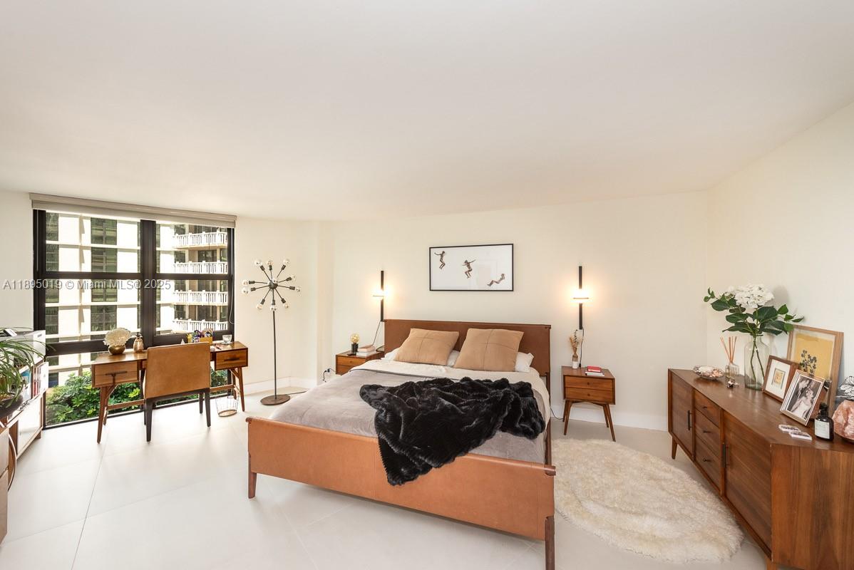 1121 Crandon Boulevard, Unit D402 Key Biscayne, FL 33149 - Photo 9 of 26 a bedroom with furniture and a large window