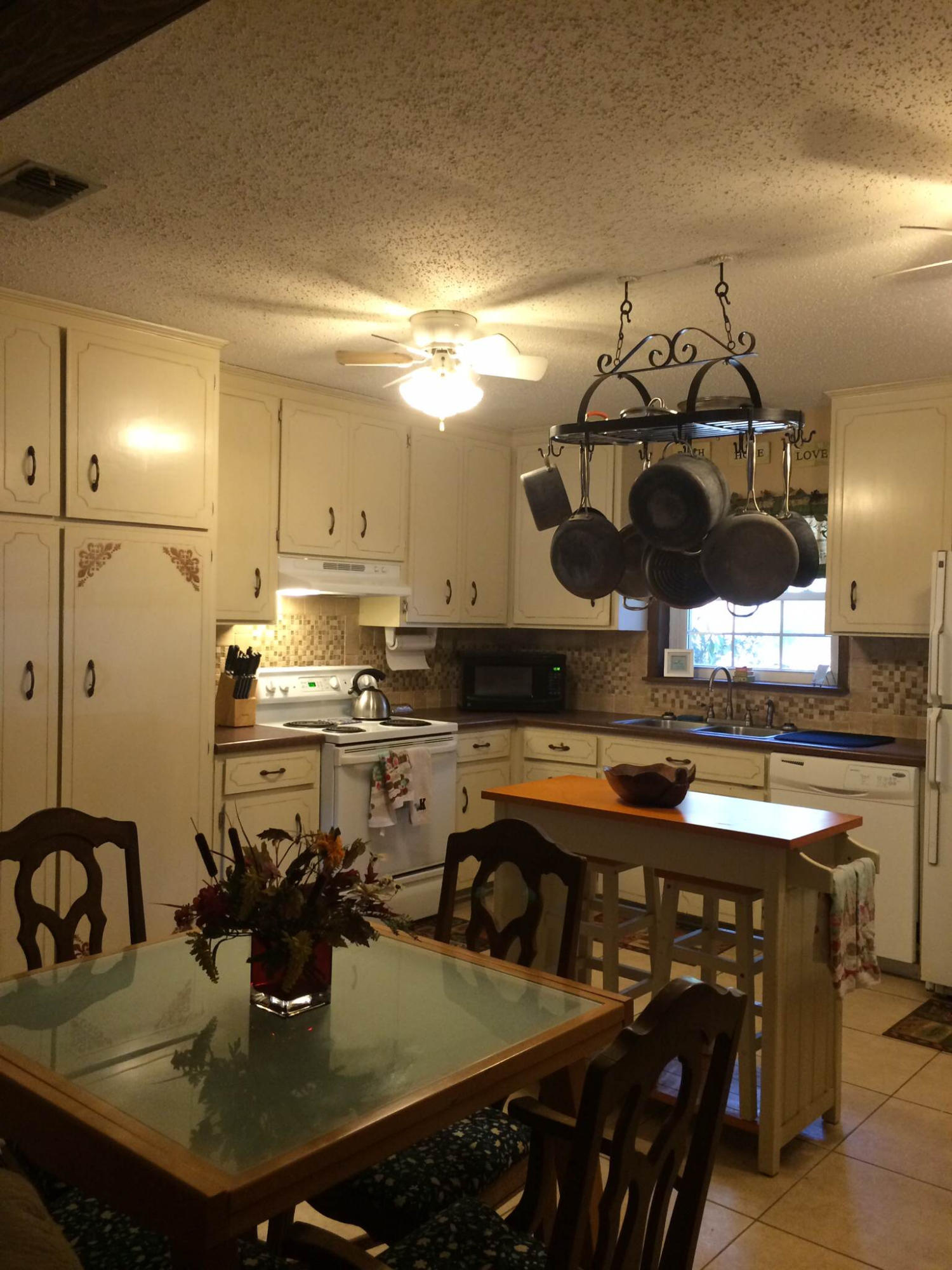 5555 Buck Ward Road Baker, FL 32531 - Photo 12 of 68 a kitchen with a sink a stove and chairs