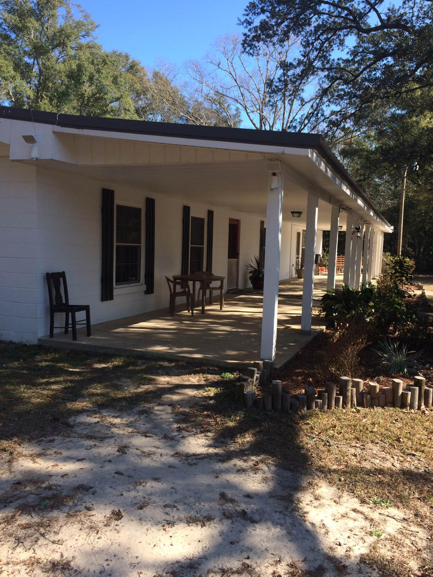 5555 Buck Ward Road Baker, FL 32531 - Photo 3 of 68 a front view of a house with a yard