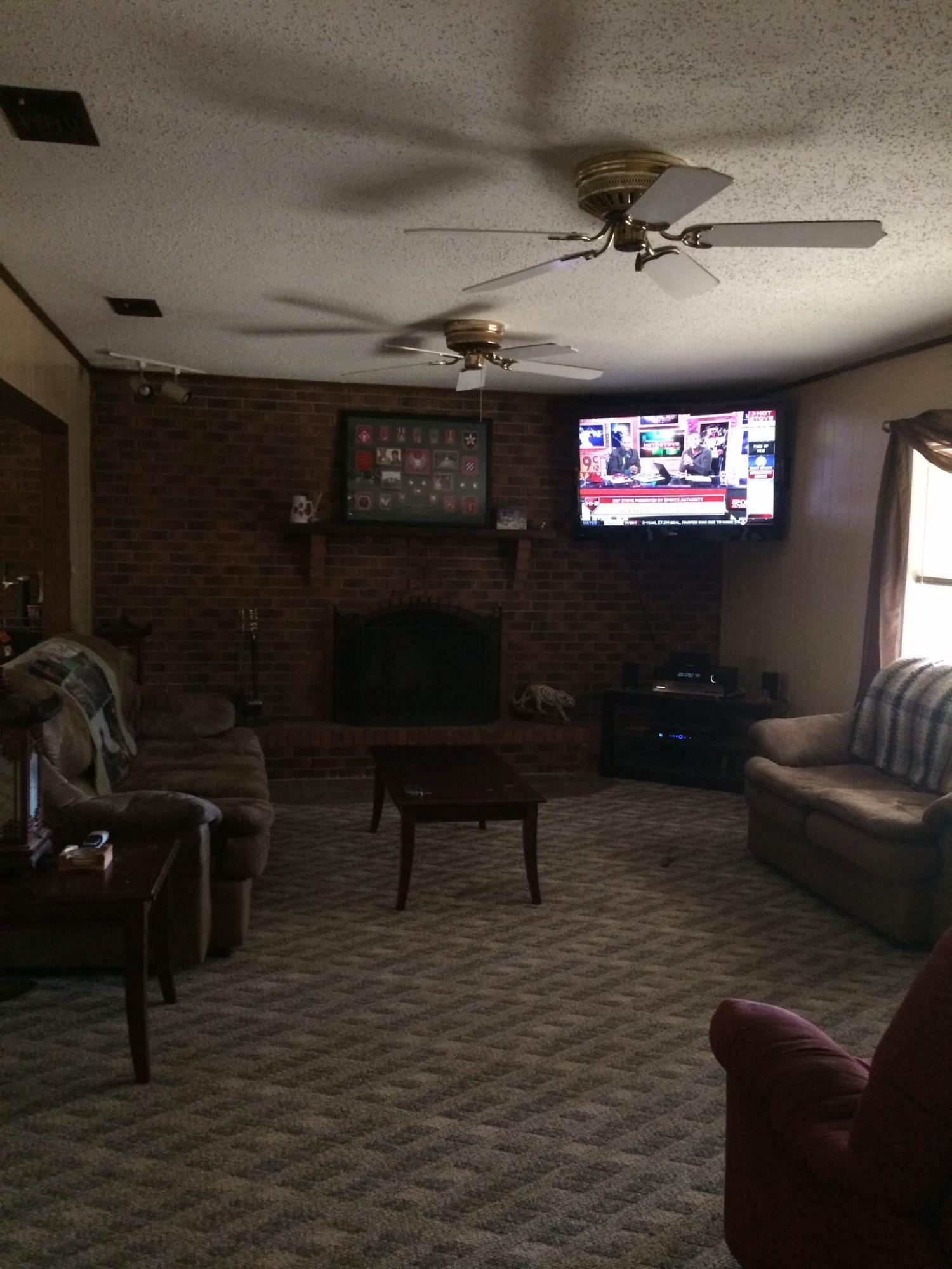 5555 Buck Ward Road Baker, FL 32531 - Photo 8 of 68 a living room with furniture and a flat screen tv