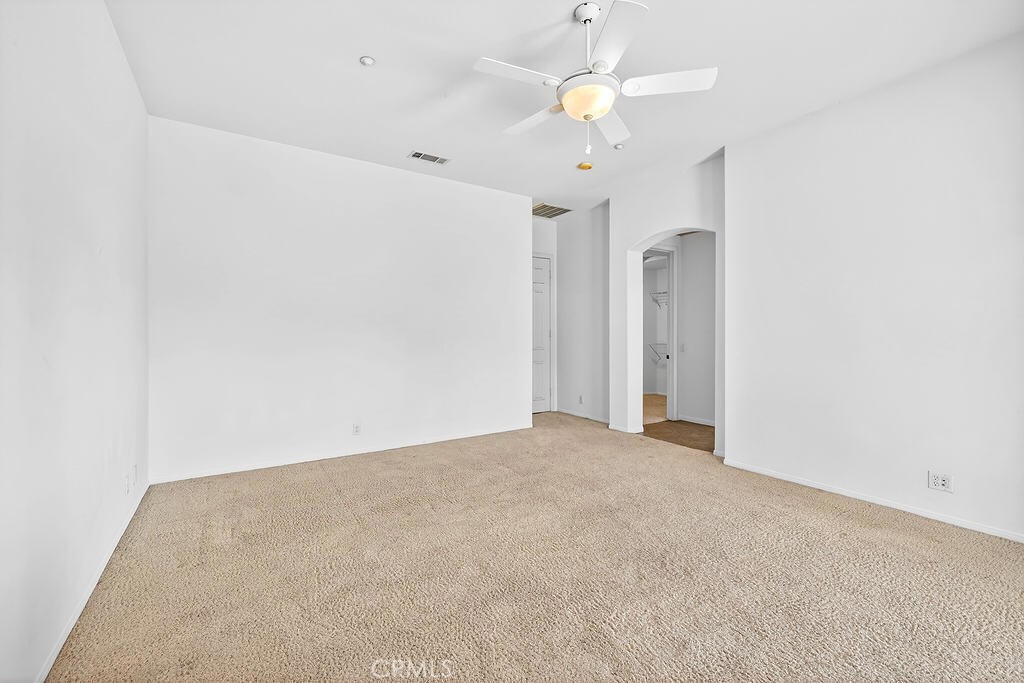 41 Vista Mirage Way Rancho Mirage, CA 92270 - Photo 13 of 25 an empty room with a chandelier fan and a chandelier fan