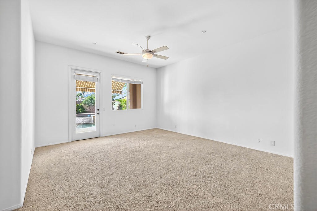 41 Vista Mirage Way Rancho Mirage, CA 92270 - Photo 14 of 25 an empty room with windows and ceiling fan