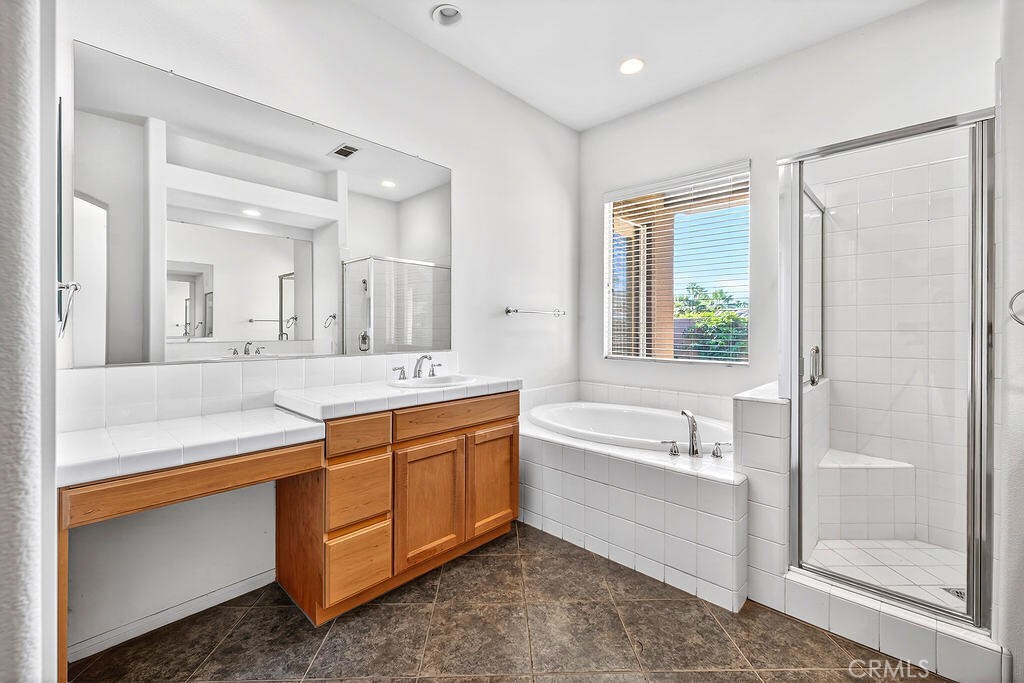 41 Vista Mirage Way Rancho Mirage, CA 92270 - Photo 19 of 25 a spacious bathroom with a double vanity sink a mirror and a bathtub