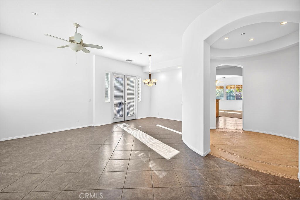 41 Vista Mirage Way Rancho Mirage, CA 92270 - Photo 6 of 25 a view of a hallway with a chandelier fan and windows