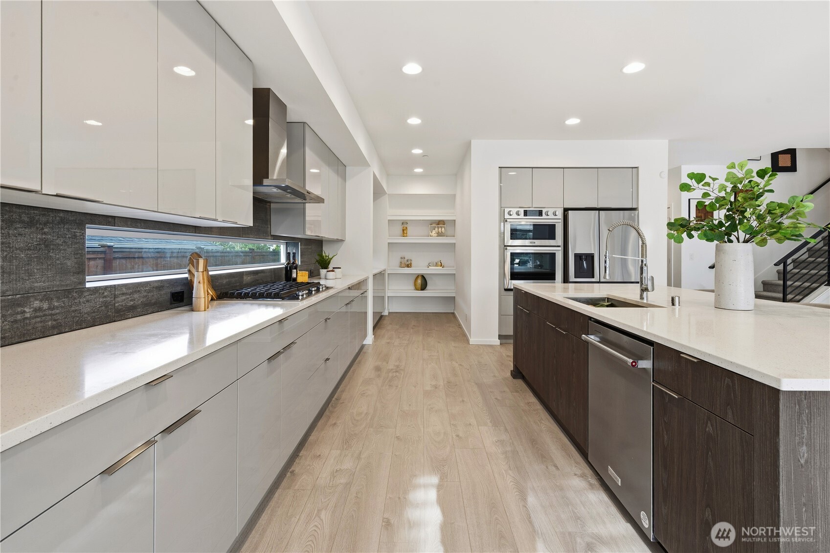 6563 Southeast 8th Street Renton, WA 98059 - Photo 11 of 40 a large kitchen with stainless steel appliances lots of counter space and a sink