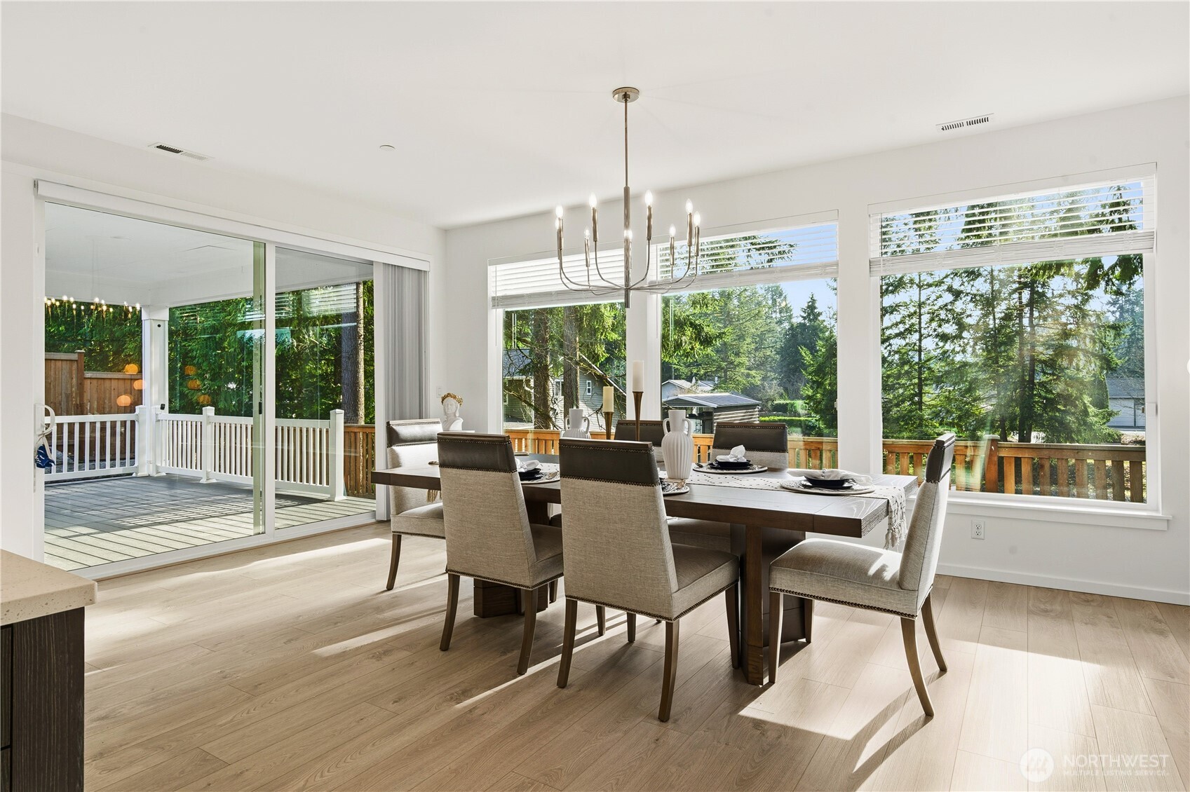 6563 Southeast 8th Street Renton, WA 98059 - Photo 12 of 40 a view of a dining room with furniture large windows and wooden floor