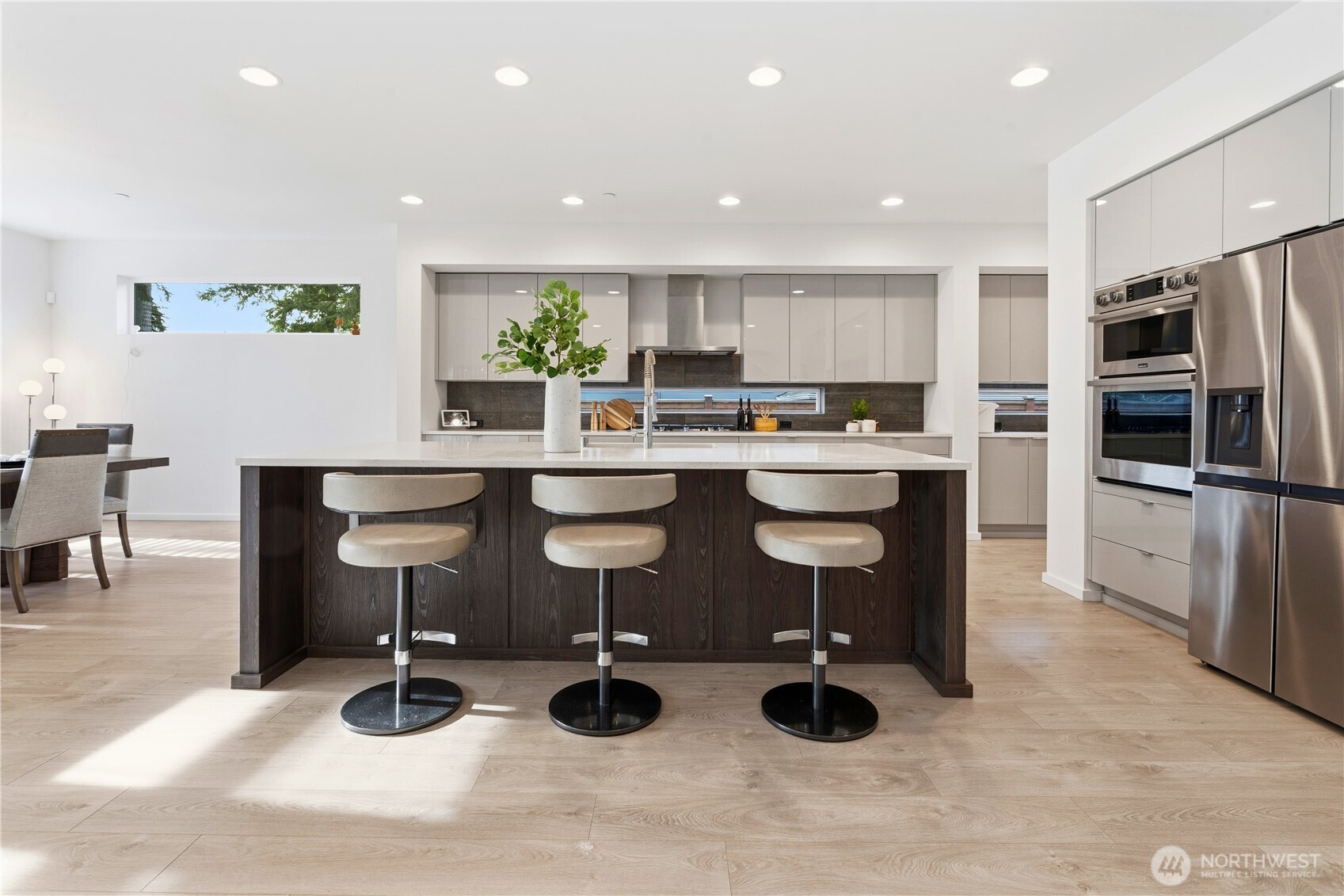 6563 Southeast 8th Street Renton, WA 98059 - Photo 14 of 40 a kitchen with a sink stainless steel appliances and cabinets