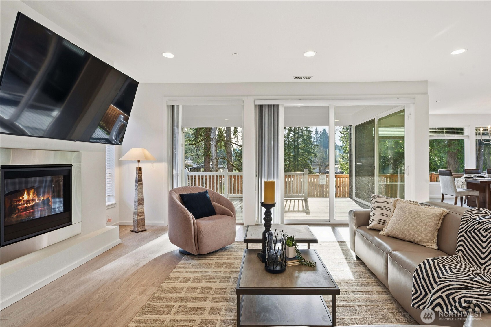 6563 Southeast 8th Street Renton, WA 98059 - Photo 16 of 40 a living room with furniture a flat screen tv and a fireplace