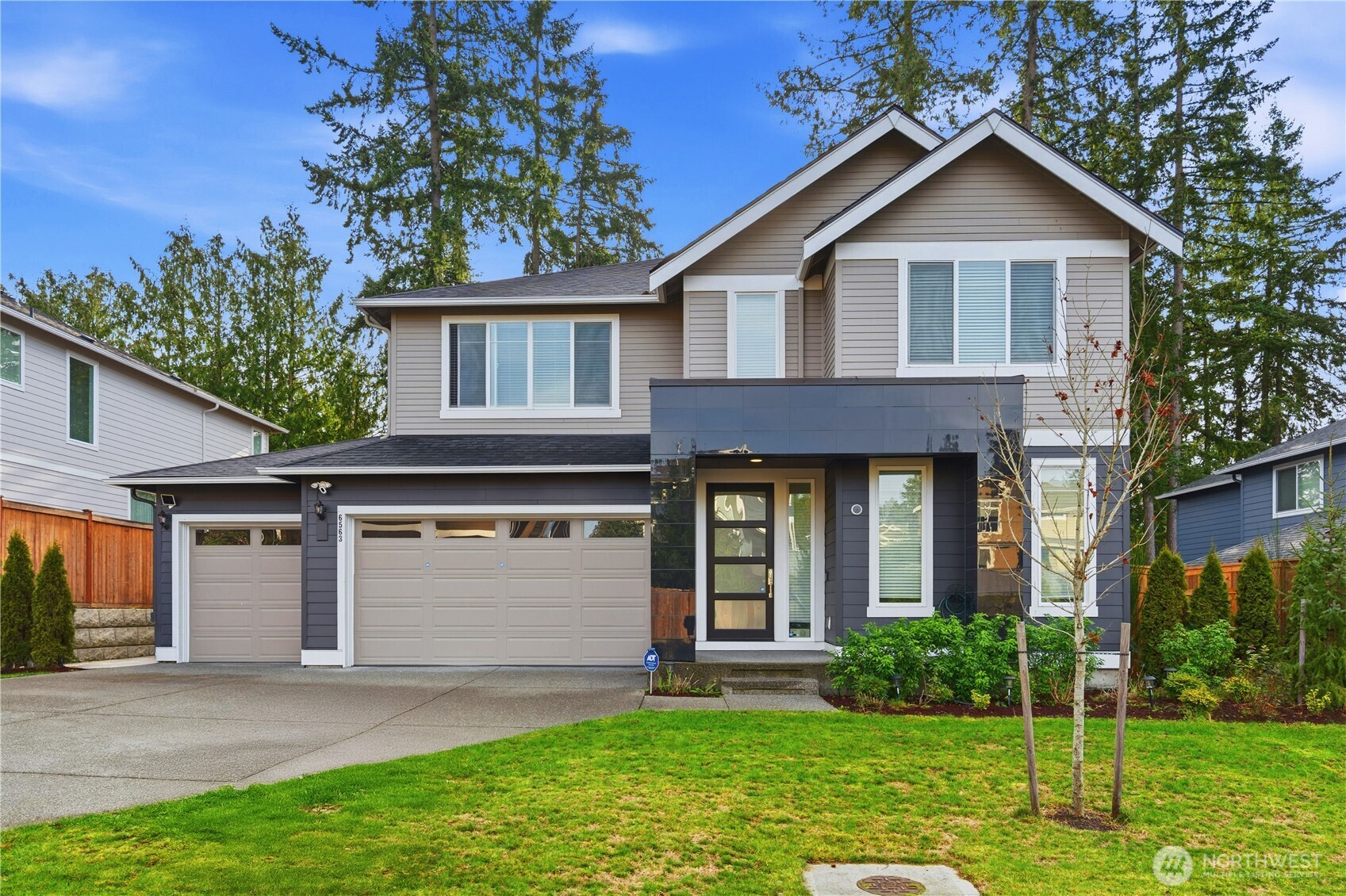 6563 Southeast 8th Street Renton, WA 98059 - Photo 2 of 40 a front view of a house with garden