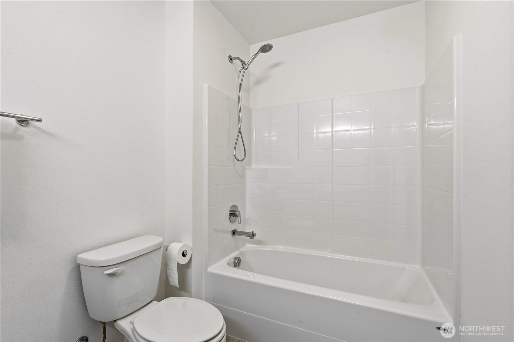 6563 Southeast 8th Street Renton, WA 98059 - Photo 35 of 40 a white toilet and tub sitting next to a bathroom sink