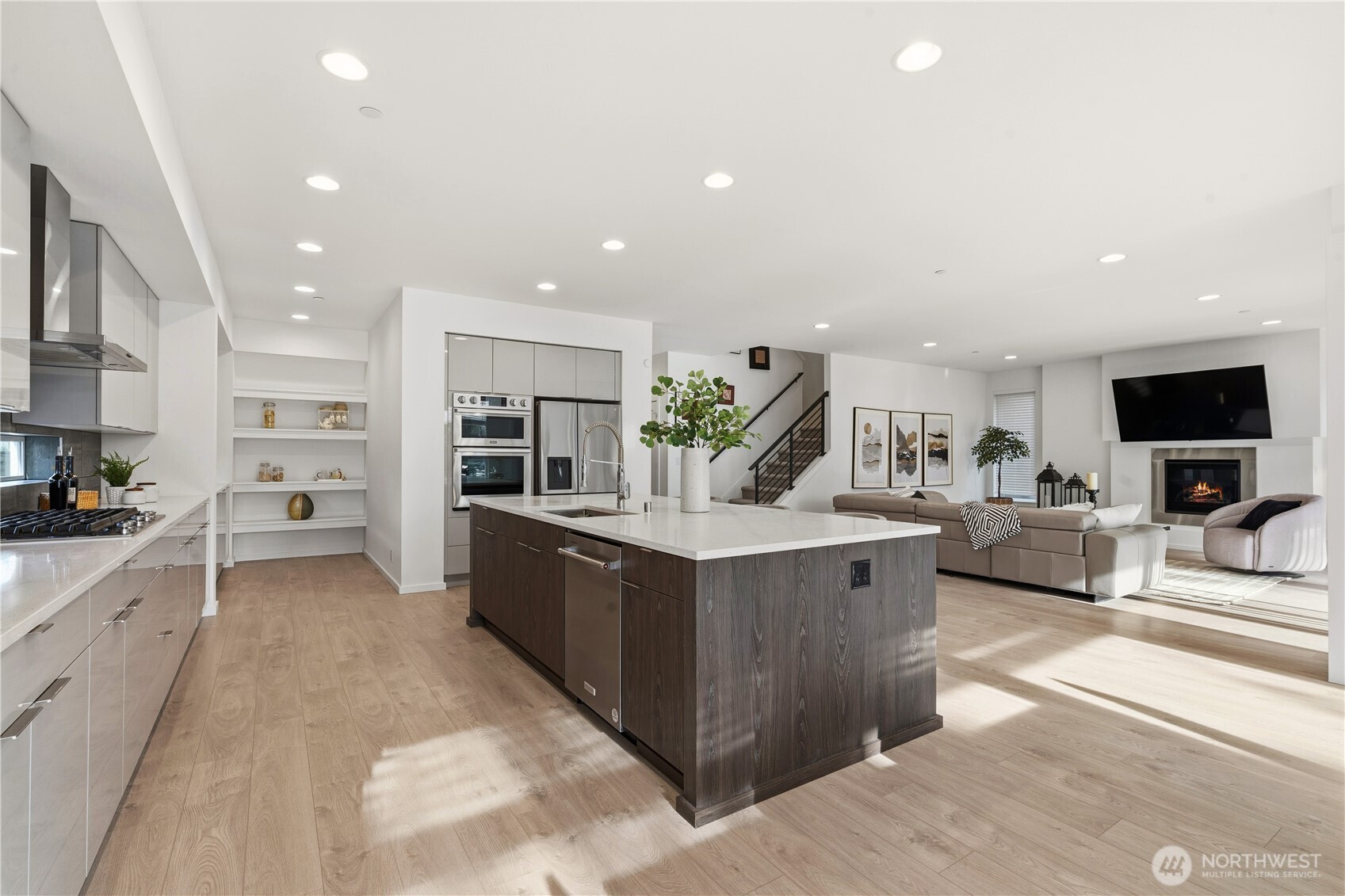 6563 Southeast 8th Street Renton, WA 98059 - Photo 10 of 40 a large kitchen with stainless steel appliances kitchen island granite countertop a large counter top and a stove top oven